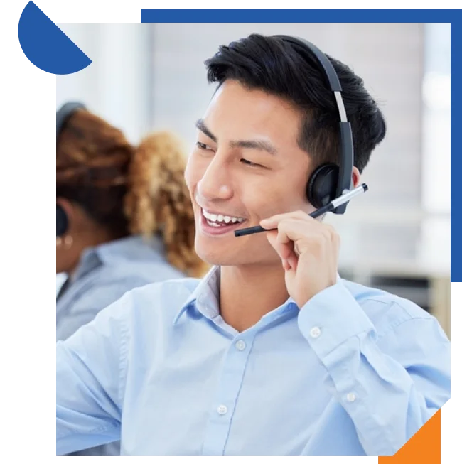 A call center agent engaged in a conversation, equipped with a headset and seated at a desk with a computer