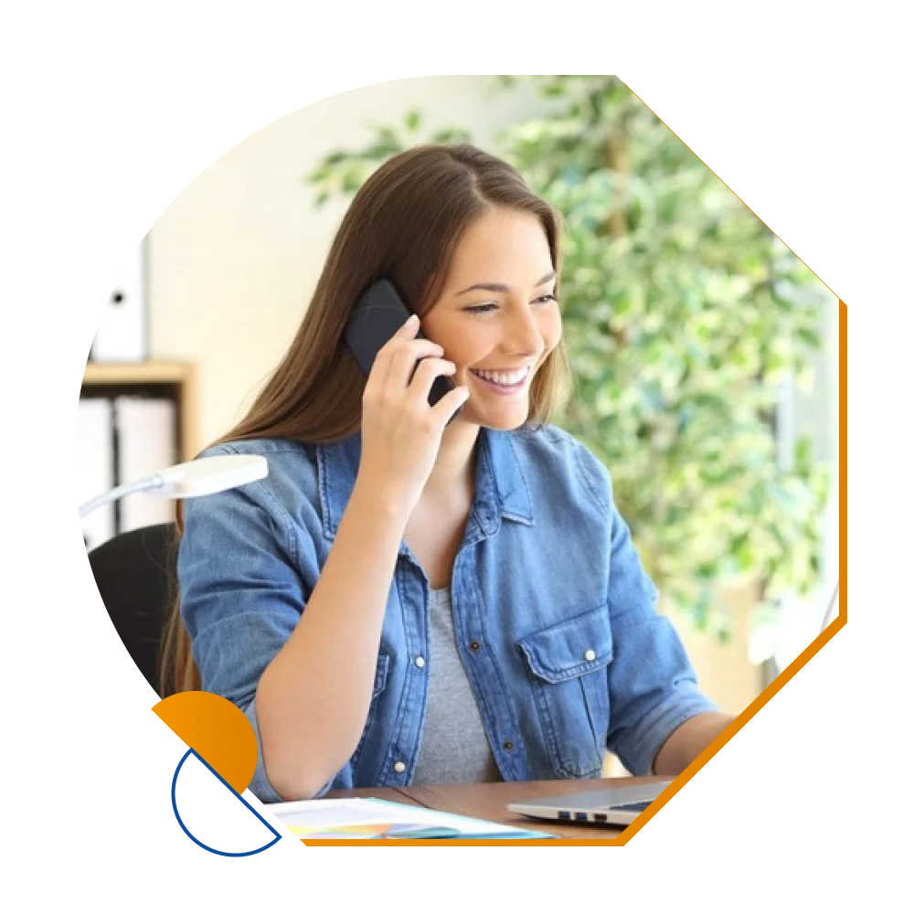 A customer service representative at a call center, engaged in a conversation, surrounded by technology and support tools