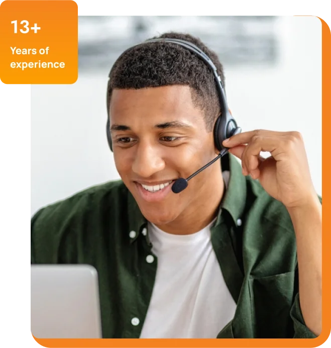 A young man equipped with a headset and laptop, concentrating on his work, possibly in a remote work environment