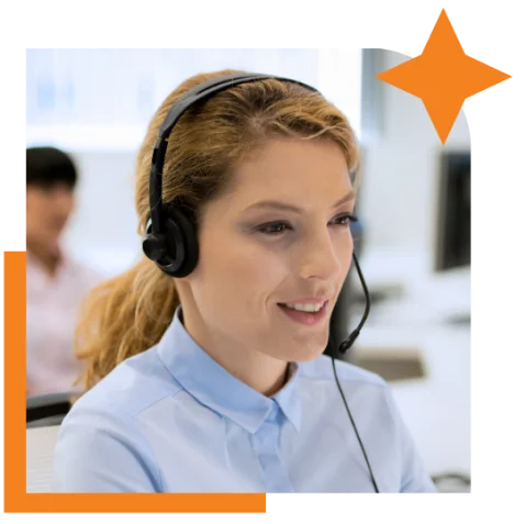 A woman in an office environment, equipped with a headset, concentrating on her tasks and communication
