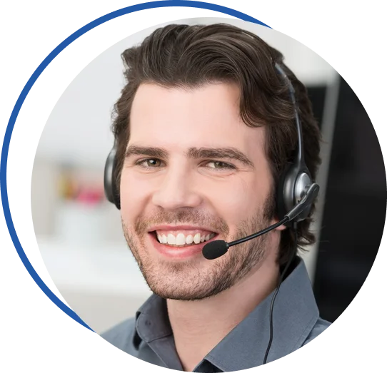 A smiling man with a headset engaged in conversation while sitting in front of a computer screen