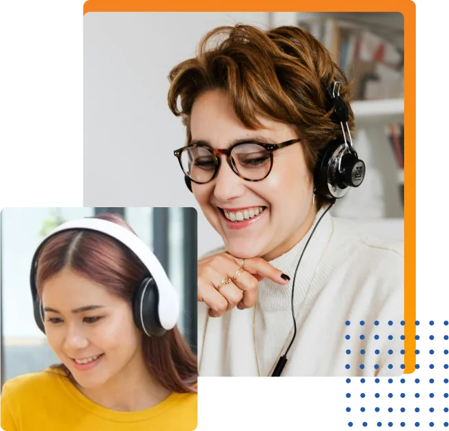 Two women wearing headphones, smiling joyfully while working together in a vibrant setting